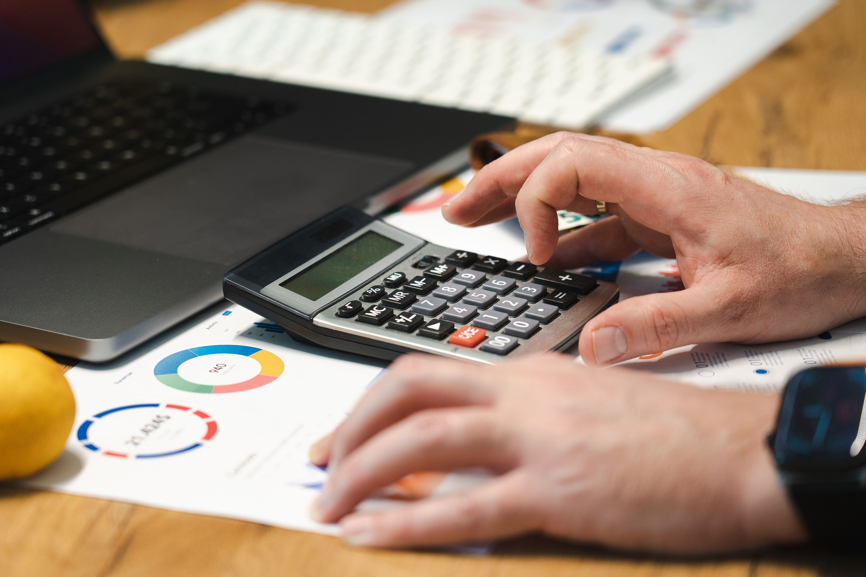 A restaurant owner reviewing financial reports on a tablet in a busy Canadian eatery