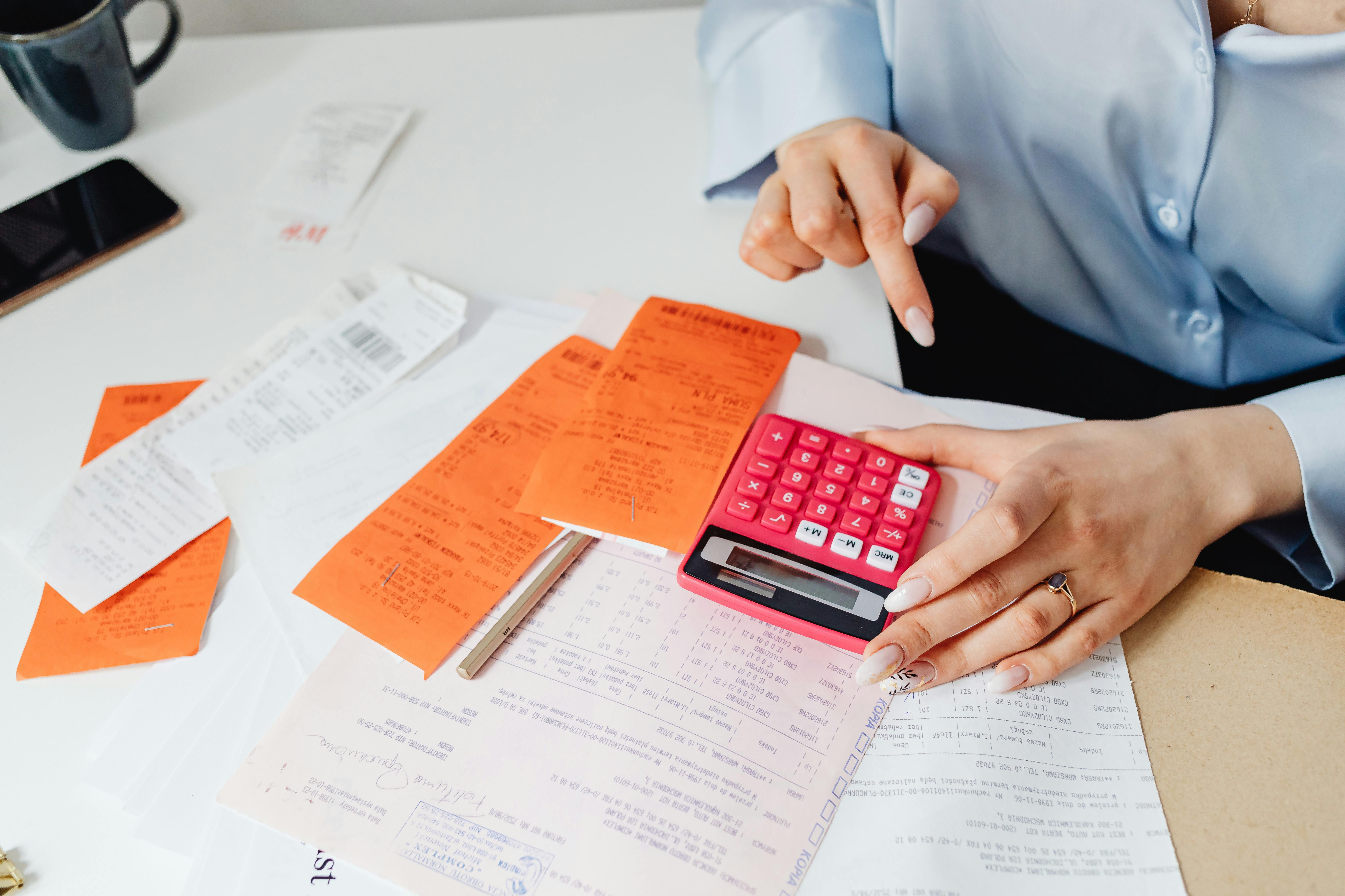 A calendar showing CRA instalment due dates with a calculator and pen on a desk.