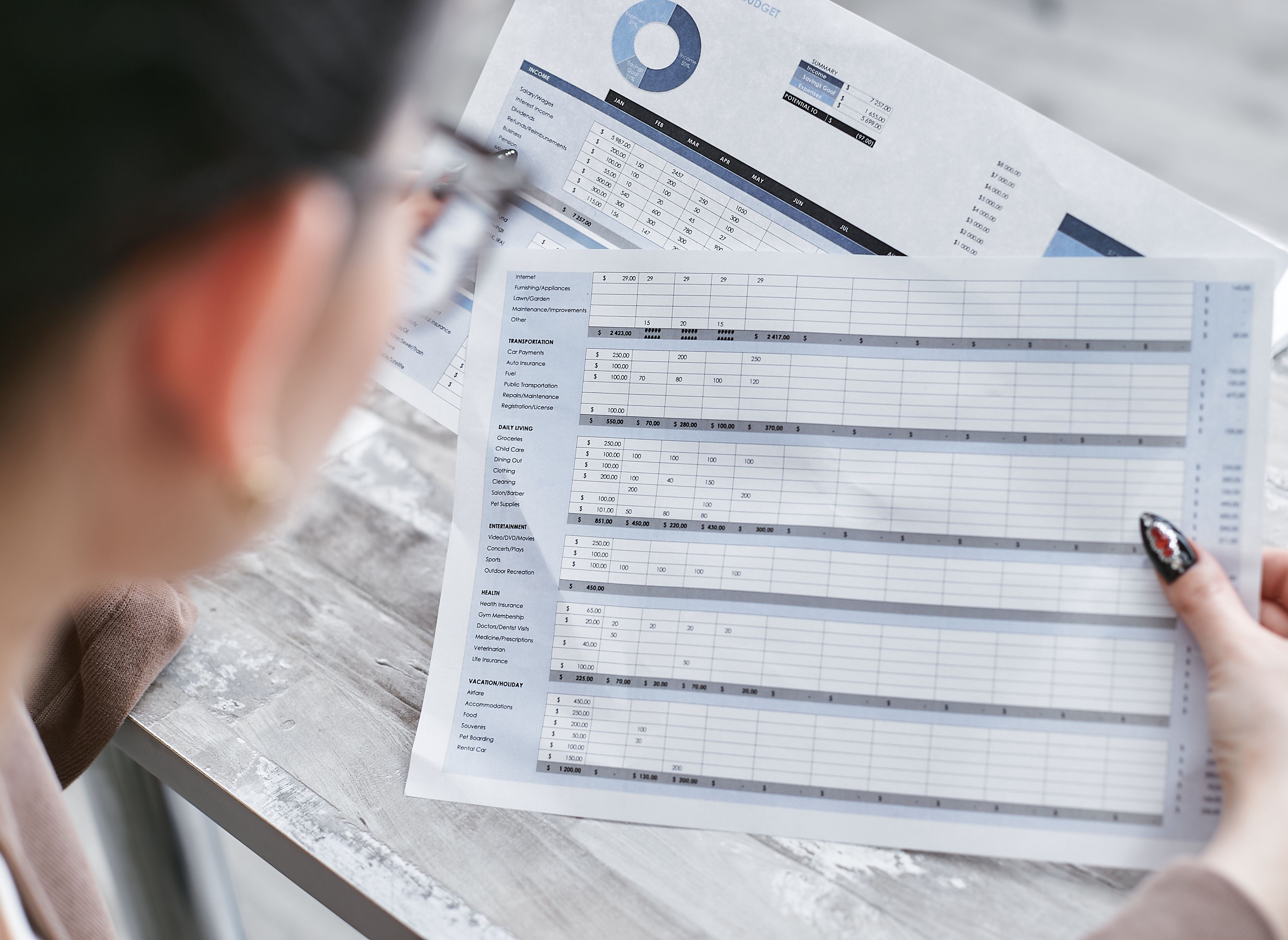 A Canadian real estate agent reviewing financial reports on a laptop with Awditify software.