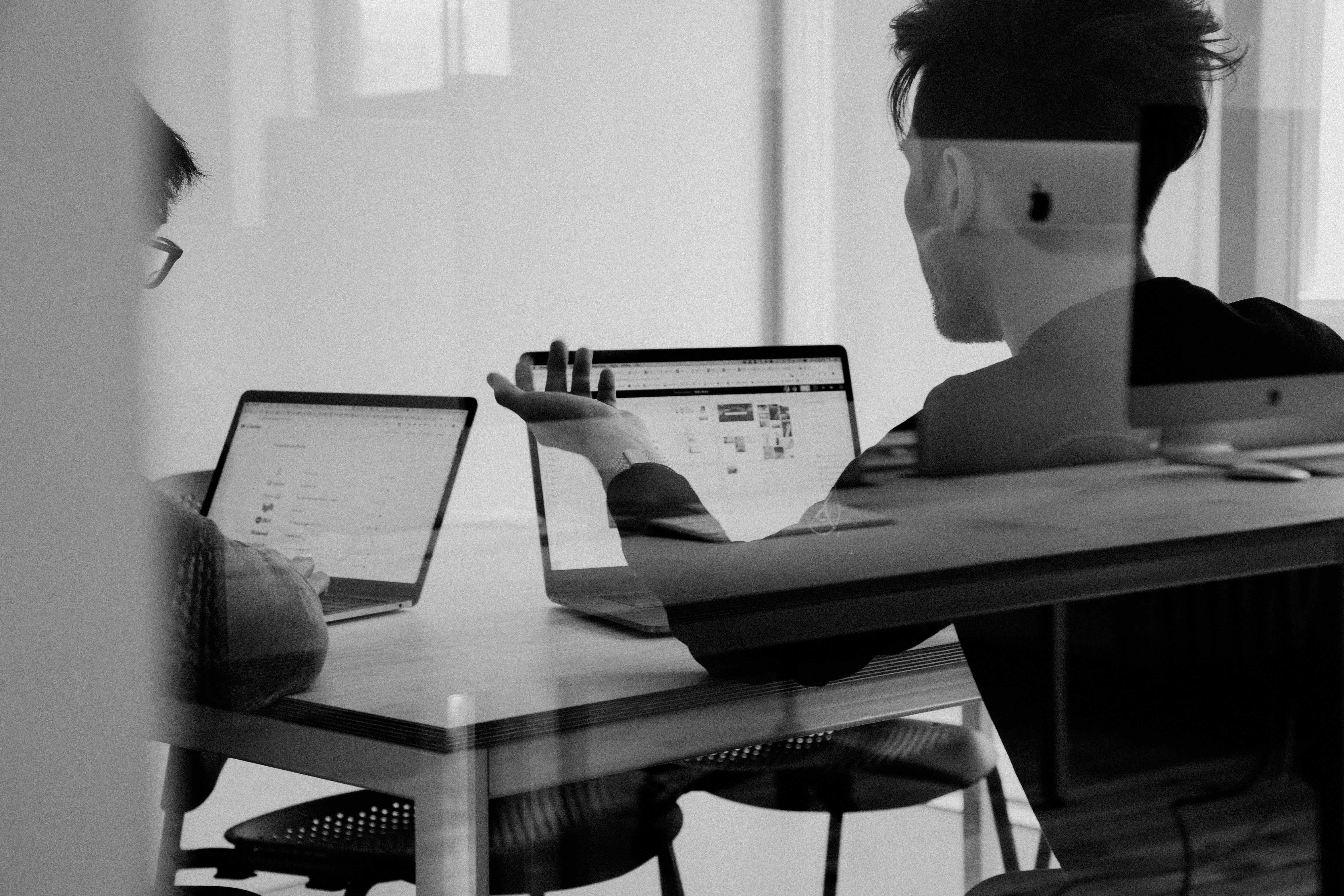 Architect reviewing financial dashboard on laptop with project profitability charts.